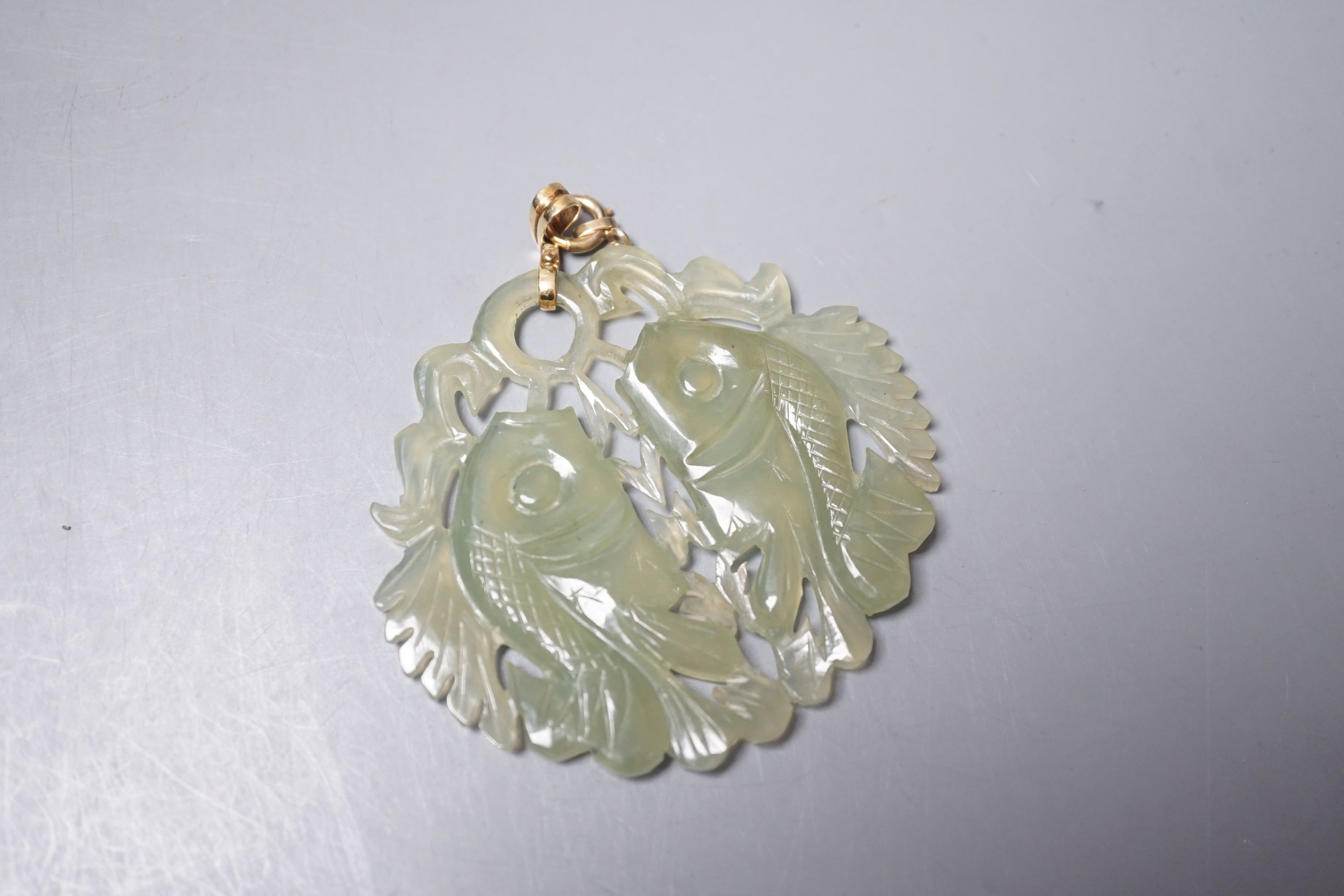 A Chinese carved bowenite jade ‘fish’ pendant